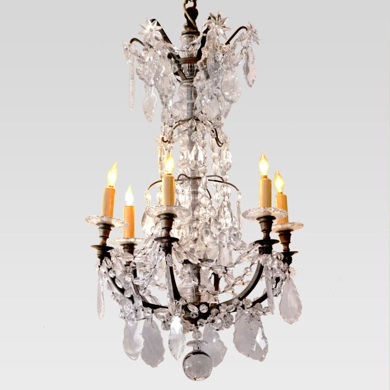Well-proportioned 19th century English crystal and bronze chandelier. Features six candle-lights on scrolling bronze frame. Excellent details with the center pole covered with faceted crystal, the drip plates with beaded edges, and large sculpted