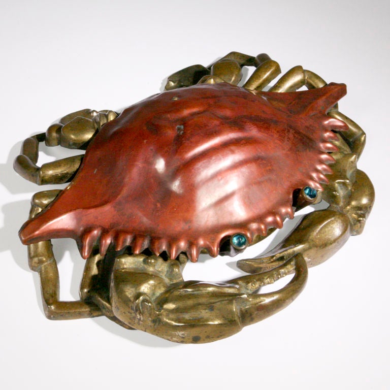 Amusing large size crab-shaped spittoon.  With a copper body, brass claws and blue glass eyes. To open the cuspidor, the gentleman steps on its front right claw...causing the top to lift up! Original oval metal insert.