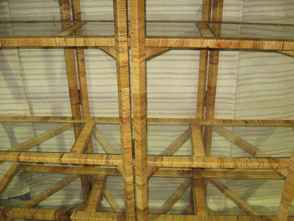 Decorative 5 piece rattan etagere, with folding frame. Each shelf has 3 glass inserts. Wonderful as bookcase, room devider, extra storage. In a living room dining or bedroom.