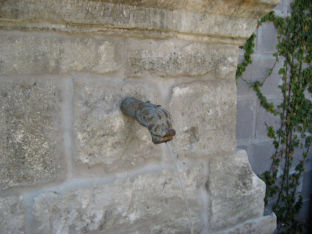Provençal stone fountain made from reclaimed stone elements.  19th c. fish detail iron fountain spout.  Basin height is 20