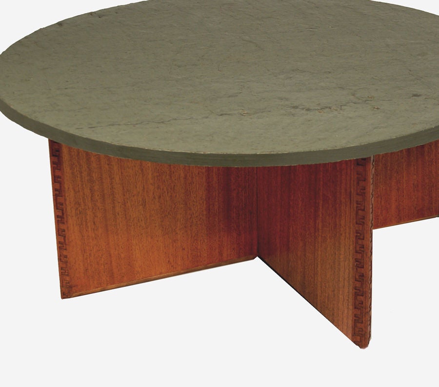Rare coffee table, round rolled slate top on cruciform mahogany base with Taliesen edge design. Very short production, only 2 years. Marked with FLW red signature and manufacturer's mark. Made by Heritage Henredon.
