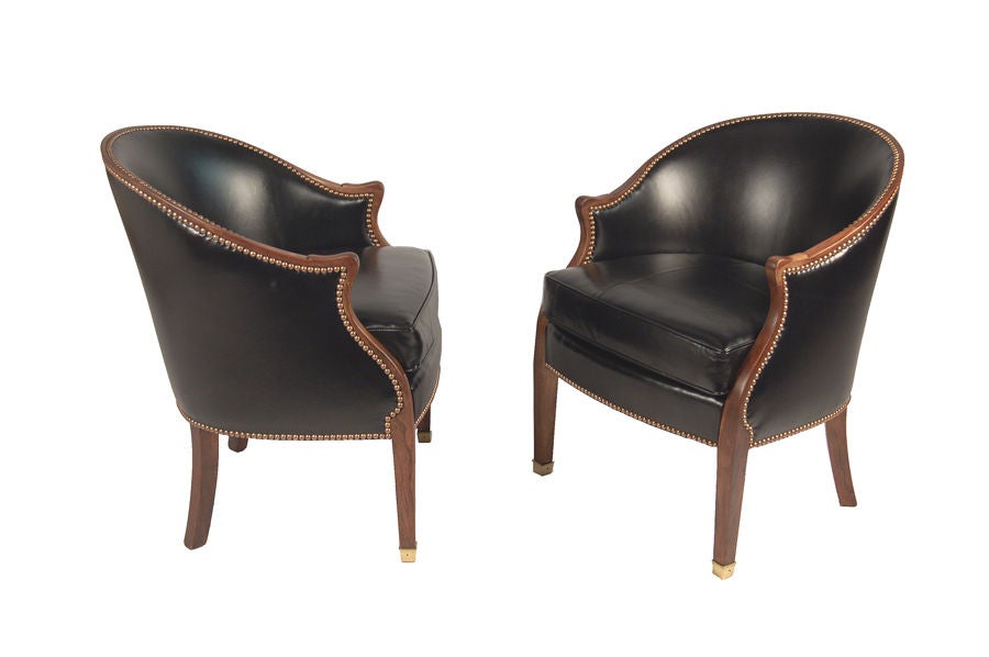 Stylish pair of easy chairs, cherry frames with new leather upholstery. Brass nailhead trim. These chairs are reduced in price from $6000 pair to $3000 pair.