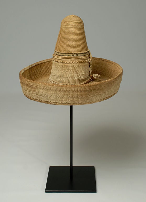 A fine and rare late 19th century Mexican child’s ‘sombrerito.' The workmanship is incredibly fine with elaborate hand woven fiber cord, straw, wire and hand woven black ribbon. Classic high crown and wide brim – circa 1880.<br />
<br