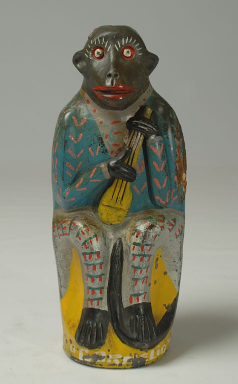 This early 20th century 'chango' from Oaxaca features a monkey strumming his yellow mandolin. Inscribed 'a Cornelia.' Original painted surface with remnants of wax seal and cork stopper. Oaxaca - circa 1930's. Mezcal, for those who are unfamiliar,