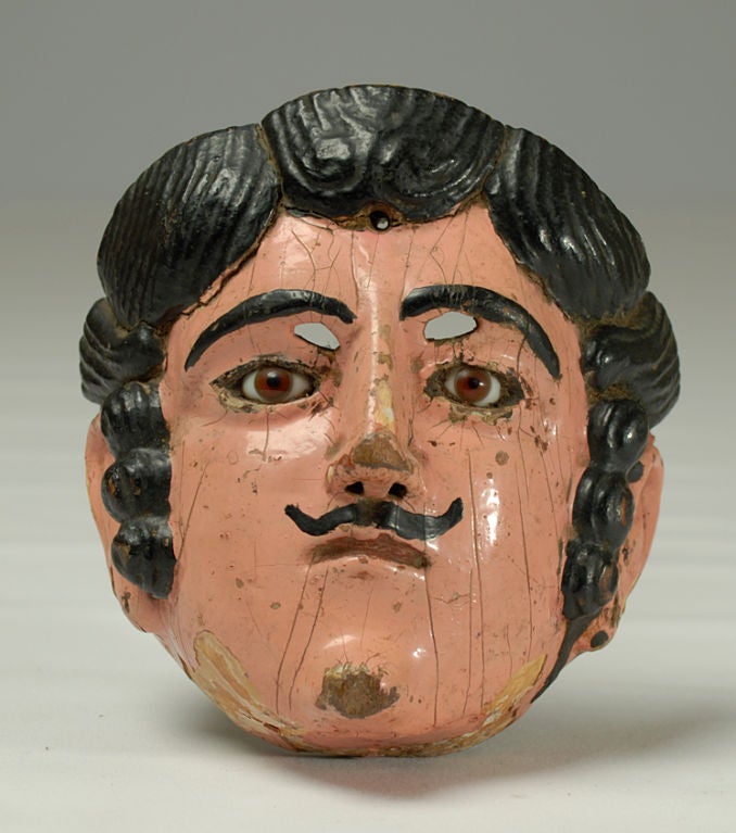 A superb early 20th century Guatemalan child's 'vaquero' (cowboy) mask. Cedar-wood with inset glass eyes, craquelure, excellent wear and patina.<br />
<br />
Dimensions: approximately 7 inches x 5 inches.
