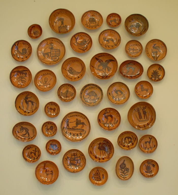 A collection of 37 ceramic red-ware plates, platters, chargers and deep bowls by Esteban Valdez, all with various animals, people and inscriptions.<br />
<br />
Dimensions: various sizes.<br />
<br />
Overall condition is excellent.