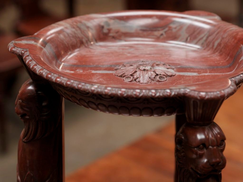 A rosso antico tazza supported by leopard monopodia