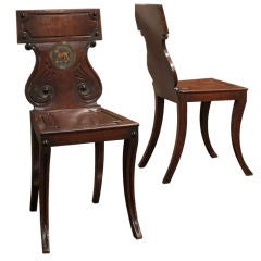 A pair of Regency mahogany and brass mounted Hall Chairs