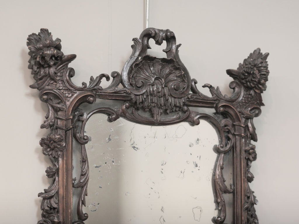 With organic elements of flowers, vines, leaves, shells, icicles and rocaille work.  The shell crest is flanked by robust corner carvings of peonies or roses over a rectangular frame. <br />
 <br />
The inner liner (very rare) is carved over the