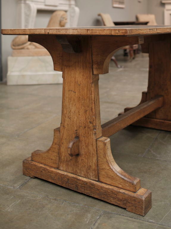 The rectangular leather inset to on tapering standard ends and trestle bases.