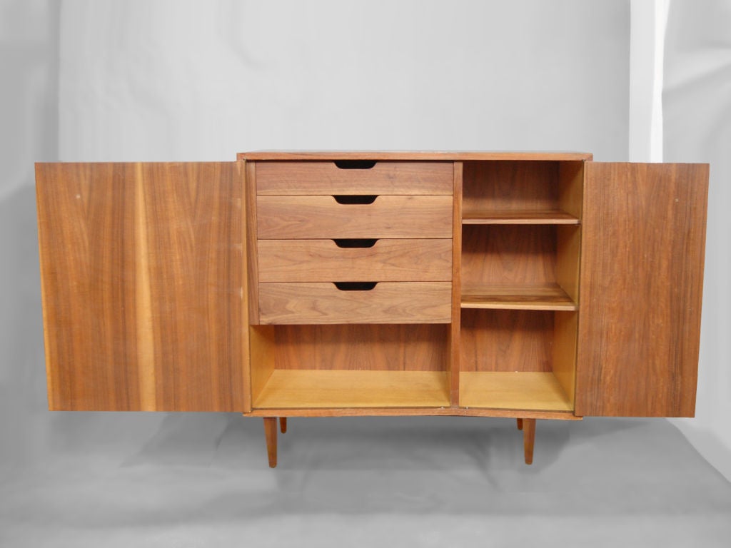 Rare pair of asymmetrical modernist cabinets in walnut by Bertha Schaefer for Singer & sons. One cabinet having 2 adjustable shelves, and 2 fixed (removable) shelves, the other having 4 drawers, and 2 adjustable shelves. Bertha Schaefer worked very