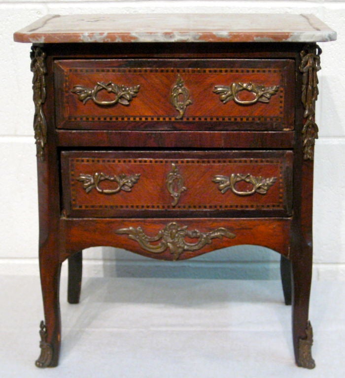 A good transitional Louis XV-XVI marquetry commode with original bronze hardware and a replaced marble grooved marble top. (originally had a wooden top)<br />
<br />
MORE ANTIQUES AVAILABLE AT WWW.OFLEURY.COM