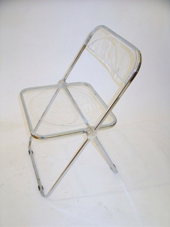 A set of four lucite and aluminum Plia folding chairs by Giancarlo Piretti for Anonima Casttelli.
