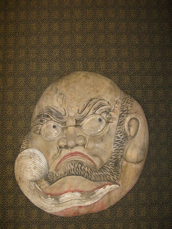 A large scale antique Japanese Kanban (shop sign) with the face of Daruma, who signifies good luck and protection. <br />
<br />
Beautifully handcarved wood, with traces of polychrome paint.<br />
<br />
With original hanging hardware at top.