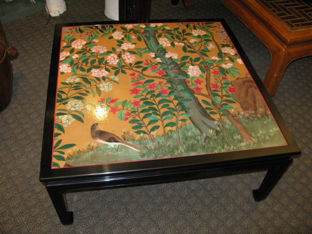 A table with hand finished black cashew lacquer base and apron.



The top has a wonderful piece of Chinese, 19th century hand-painted wallpaper on a tobacco colored ground, with design of flowers, tree trunk and bird.
