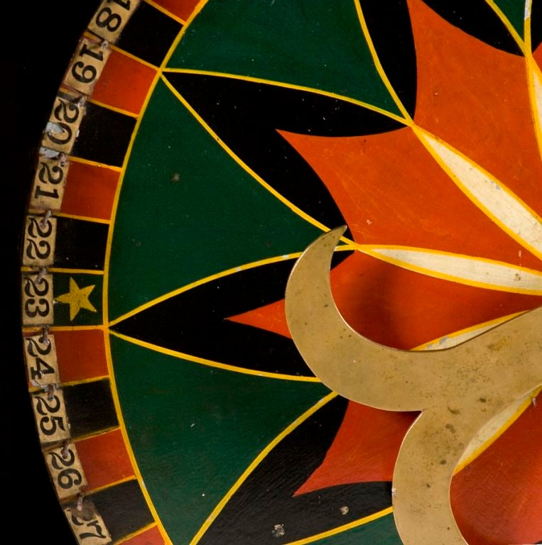 PENNSYLVANIA GAME WHEEL WITH STRIKING GRAPHICS, GREAT COLORS, AND WHIMSICAL BRASS SPINNER, 1890-1910:<br />
<br />
Found at a fire house outside Hanover, Pennsylvania in York County, this strikingly graphic gaming wheel, brightly painted in forest
