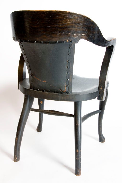 Wonderful black oak vintage library chairs. There are five in total. Two differ slightly in that they have leather backs. They are priced individually.
