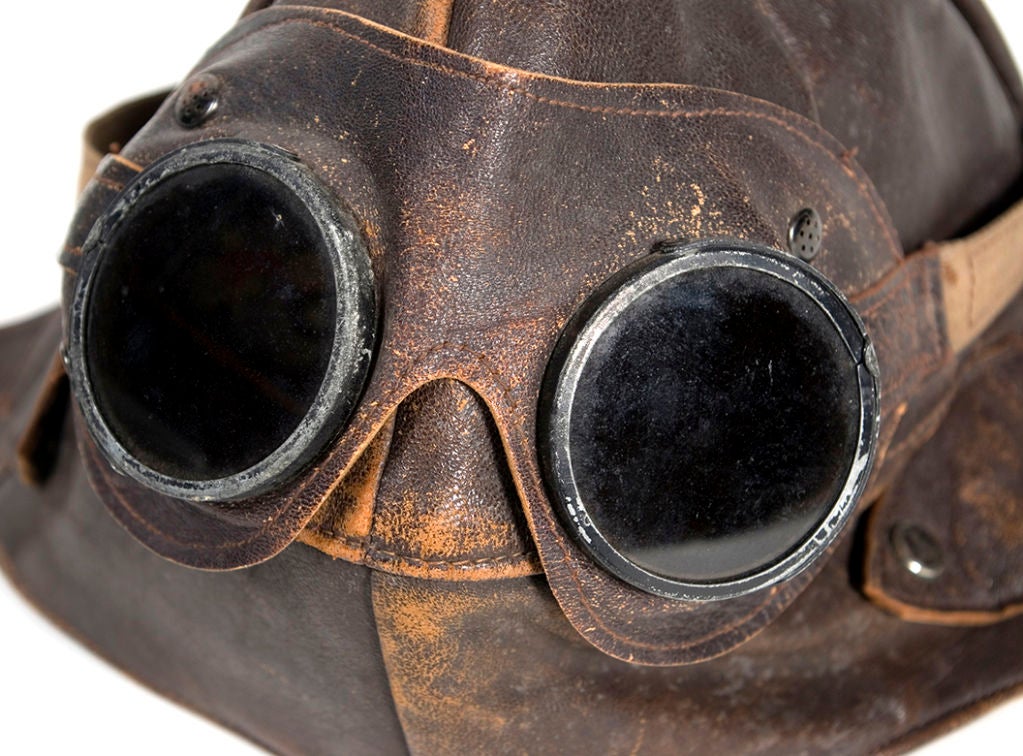 This vintage leather flying hat with straps comes with the original matching pair of goggles. The leather is of excellent quality. It's fairly small in size.