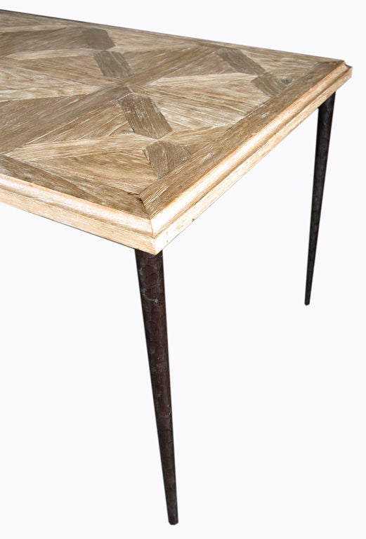 Stunning contemporary Parquet table top on a blackened steel base.