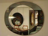 An Oval Wall Mirror in the style of Fontana Arte