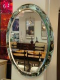 A Large Oval Wall Mirror in the style of Fontana Arte