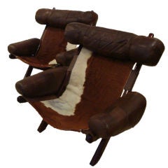 A Pair of Modernist Lounge Chairs in Stained Wood and Leather