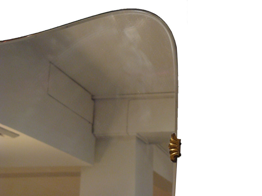 A Mid Century Frameless Shield Shaped Wall Mirror
