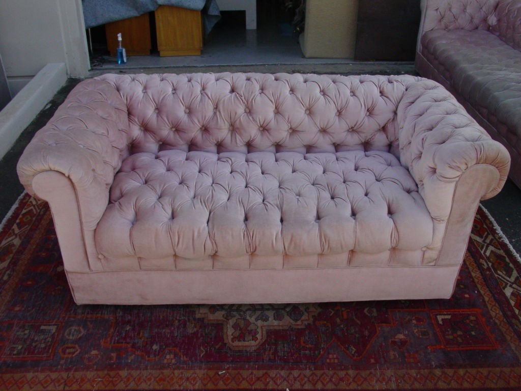 Really dynamite.  Classic chesterfield two seat sofa, extensively button tufted, in original pink cotton/rayon blend velvet in imitation of linen velvet.