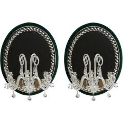 A pair of three-light mirrored sconces. Antique A pair of three-light mirrored sconces.