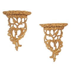 A pair of George III carved giltwood brackets.
