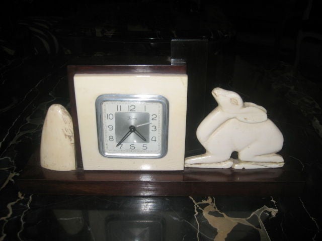 Fabulous rosewood and ivory clock perfect for desk or vanity table. In good working condition.