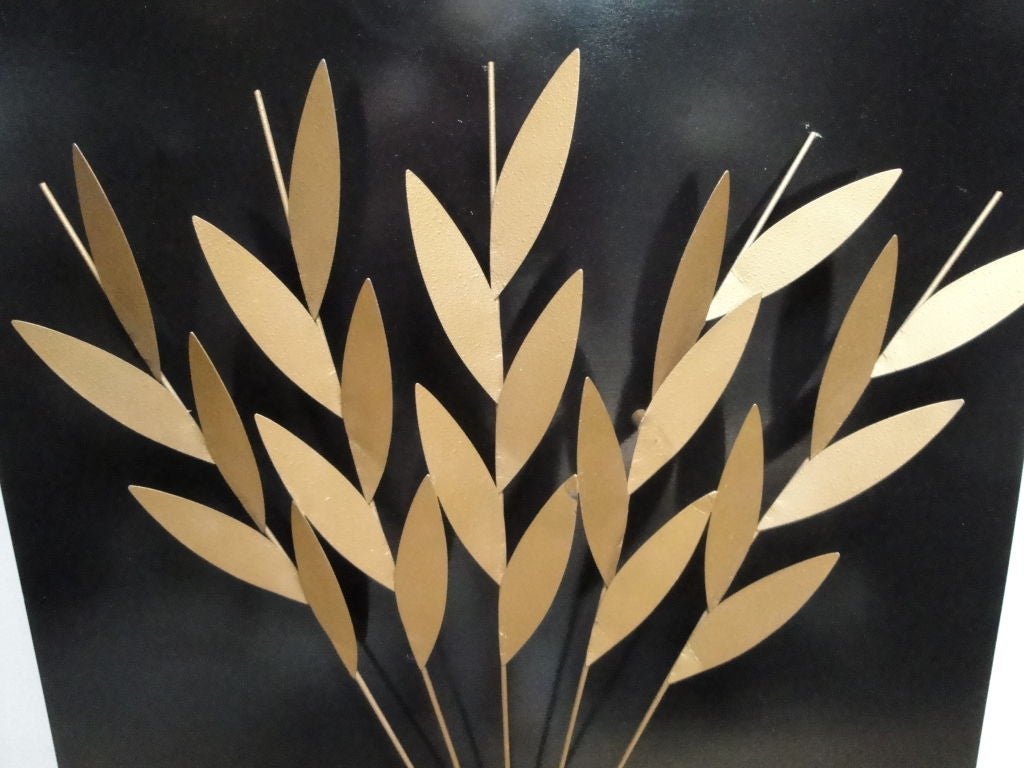 Metal wheat mounted on lacquered wood.