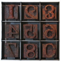 Set of Nine Industrial Stamps in Custom Fabricated Steel Grid