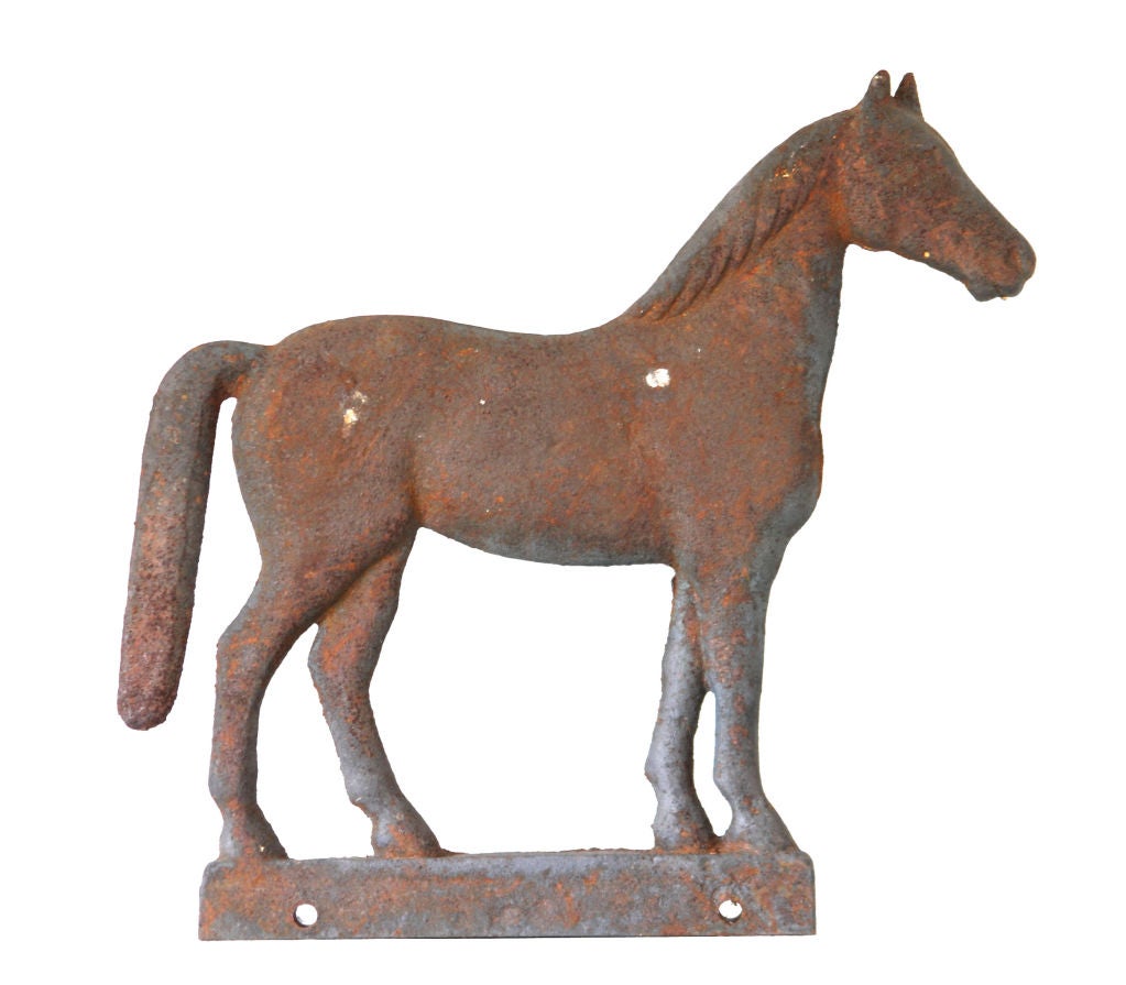 Cast iron longtail horse windmill weight with significant remnants of old orange paint over rusted surface.  Manufactured by Dempster Mill Manufacturing Company, Beatrice, Nebraska.  Illustrated in Milt Simpson's 