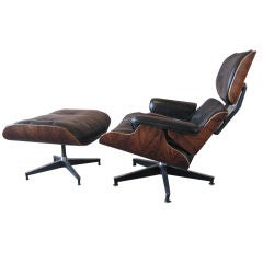 Early rosewood lounge chair and ottoman by Charles Eames