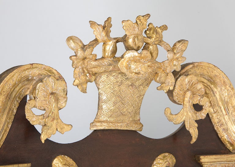Fine 18th century mahogany and gilt mirror with an original gilt basket finial,<br />
flower and vine side swags and a gilt incised inner border. This  type of mirror<br />
was often used in 18th century Philadelphia interiors. Provenance Israel