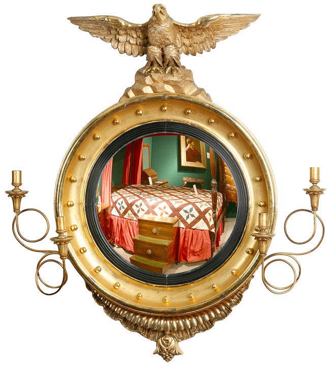 Fine gilt convex mirror with a spread eagle surmount, double candle arms the bottom with a carved drop finial, almost 

identical to a pair in the Peabody Museum's Pierce-Nichols house in Salem Mass.