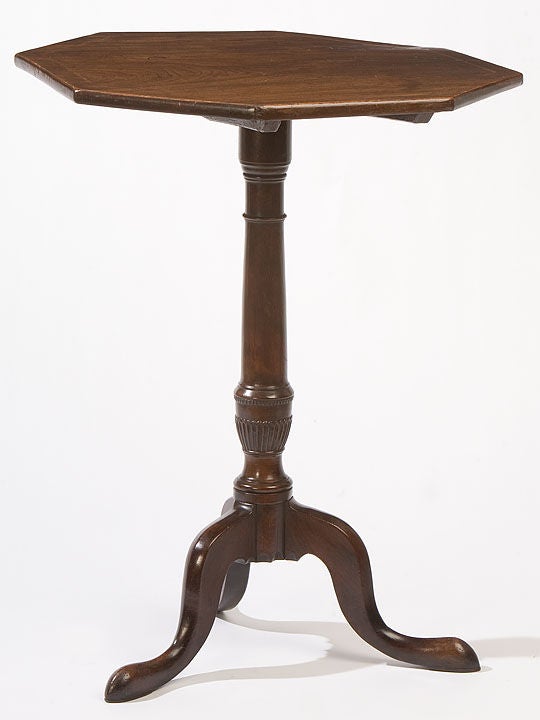Mahogany octagonal top candle-stand with a pedestal base having a<br />
fluted urn supported with a tripod with cabriole legs