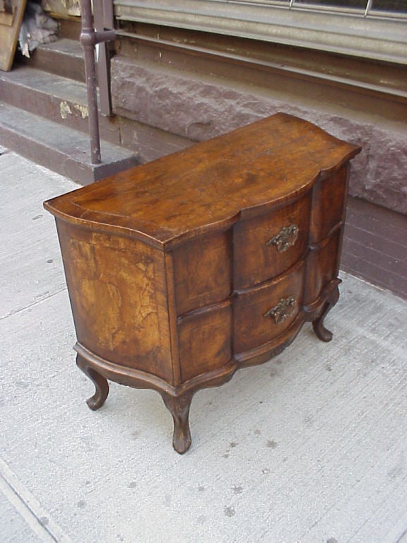 Petit Baroque style commode of serpentine shape, on cabriole legs with wo drawers.
Our pieces are left in lived-in condition, pending our custom conservation and polish to preference.
On consignment from a sophisticated collector.