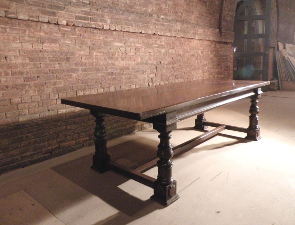 Magnificent, large Bolognese Dining Table. The typical, bold turned legs joined by H-stretcher, large overhang at the ends, beautiful patina.
