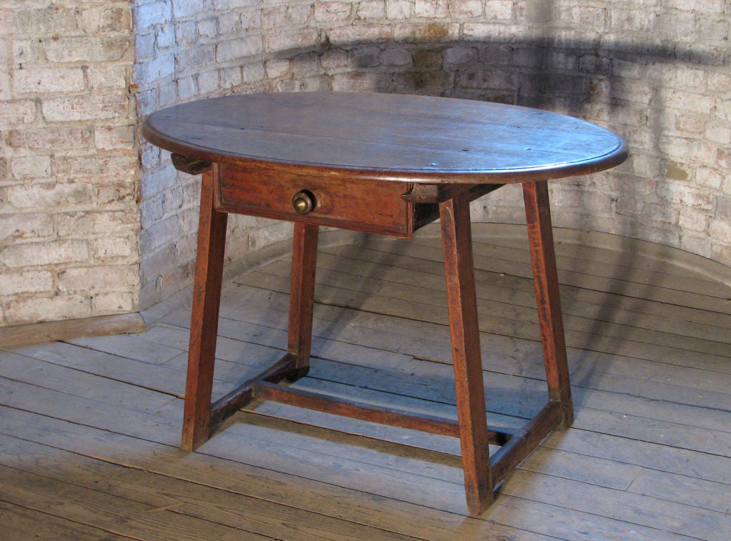 Wonderful little oval table / desk. The straight splayed legs joined by H-stretcher, one-drawer, beautiful warm color.
Our pieces are left in lived-in condition, pending our custom conservation and polish to preference.
On consignment from a