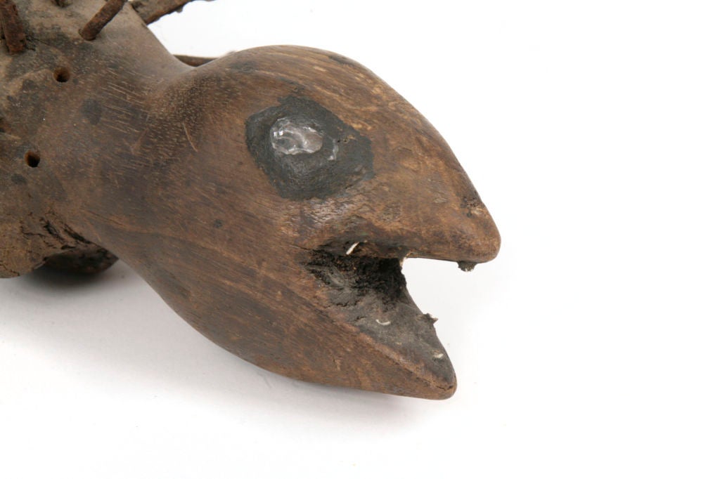 Serpent fetish nail sculpture from the Congo, central Africa circa early 1920's. The figure has mirrored eyes to house the ancestral spirit or 'nkisi force' and patinated nails in the torso. Nails are driven into the effigy during ceremonial ritual