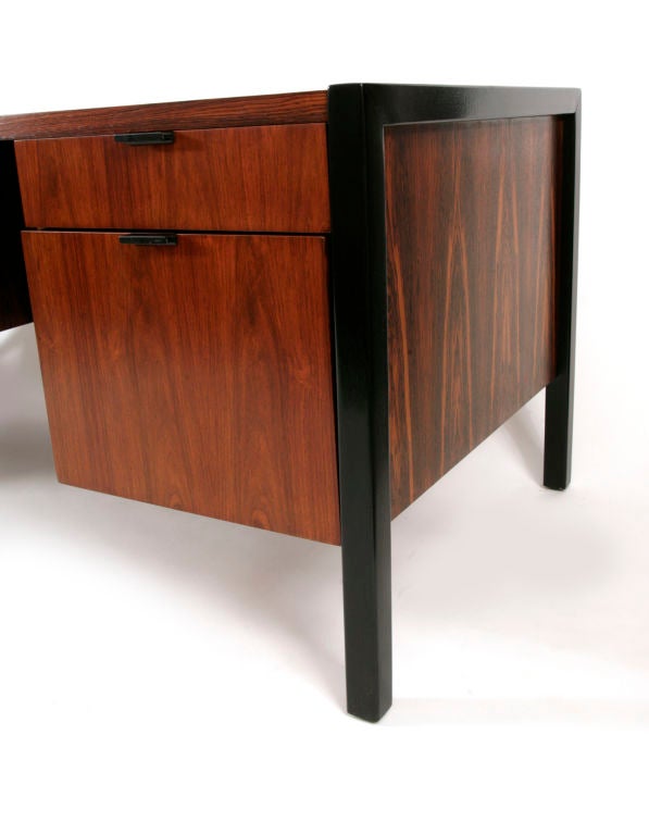 George Nelson for Herman Miller executive desk circa mid 1960's. This five drawer desk is done in beautifully grained Brazilian rosewood juxtaposed with black lacquered legs and black metal drawer pulls. Excellent restored condition.