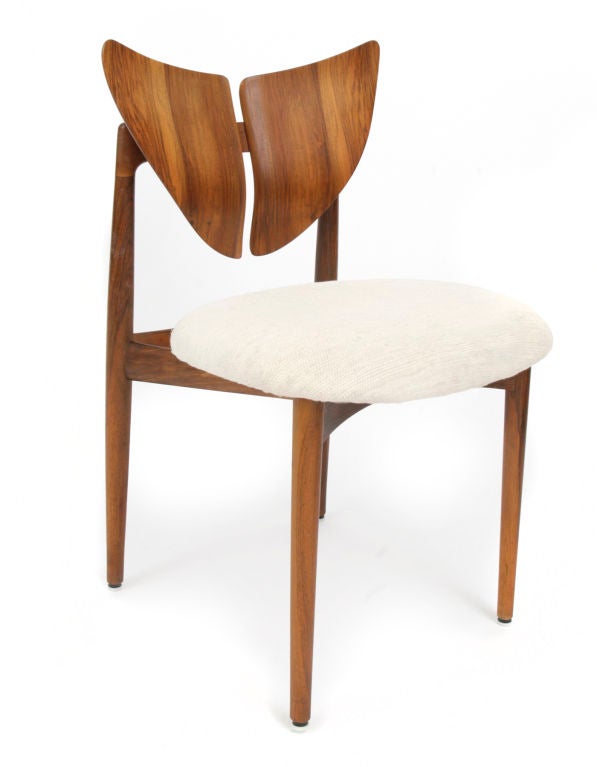 Stunning set of 6 dining chairs designed by Kurt Ostervig for Brande Modelindustri circa early 1960's. These sculptural chairs are done in incredibly grained solid rosewood with subtly curved butterfly backs and tapering legs and stretchers. The