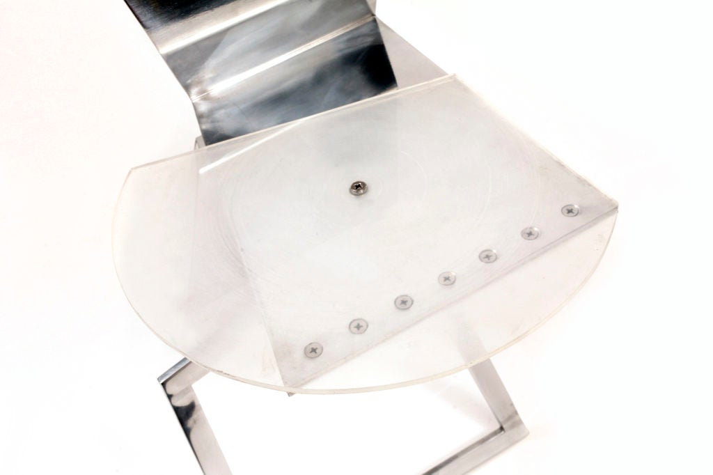 Mirror polished aluminum and Lucite one off chair by Robert Whitton, circa late 1980s. This example is from Mr. Whitton's 'askew axis' series and features a semi circular Lucite seat juxtaposed with hard edge linear aluminum. Excellent original