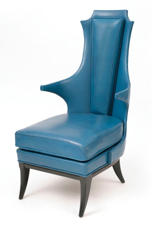 Pair of spectacular Italian wingback chairs circa late 1950's. These sculptural beauties have wonderful curved arms and have been recently upholstered in a supple blue leather.<br />
The legs of the chairs are klismos style and are done in dark