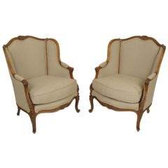 Pair of Louis XV carved walnut bergeres