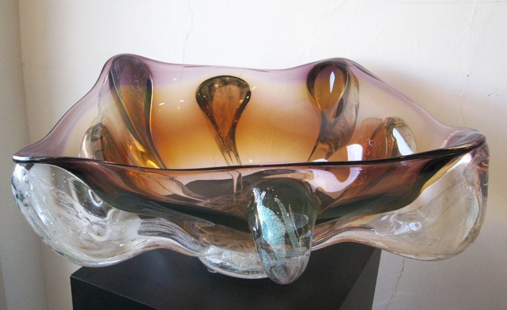 Monumental art glass bowl by artist Will Dexter. He is known for his massive sculptural vessels made in dynamic swirling amorphic forms of color with precious dichroic glass. He studied marine biology and grew up on the Gulf coast of Florida which