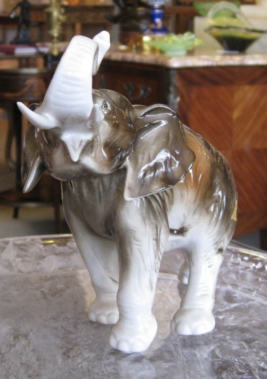 A beautifully crafted and hand painted porcelain elephant by the Royal Dux Bohemia Porcelain works with a stamp, applied pink porcelain triangle with stamp and a foil label. It was made in Czechoslovakia.