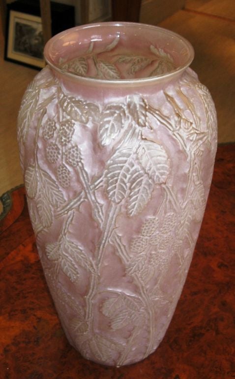 A sculptured art glass vase by Phoenix Glass in a berry design in frosted pink coloration. Phoenix Sculptured Art Glass was molded glass and colors were applied to accent the raised design and then refired. It has a slightly opalescent quality There